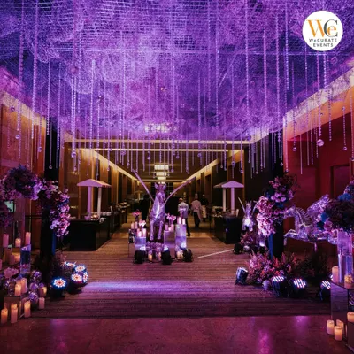 The entrance to the celestial-themed Sangeet set the tone for the entire evening. A dramatic walkway lined with candles, floral arrangements, and shimmering pegasus statues led guests into a magical space.