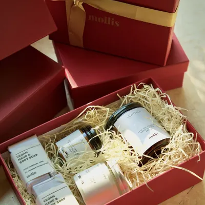 This is my large Diwali gift box, a perfect blend of elegance and indulgence. This burgundy box with a golden ribbon contains a luxurious 200g candle, two 100g candles, and two handcrafted soaps.