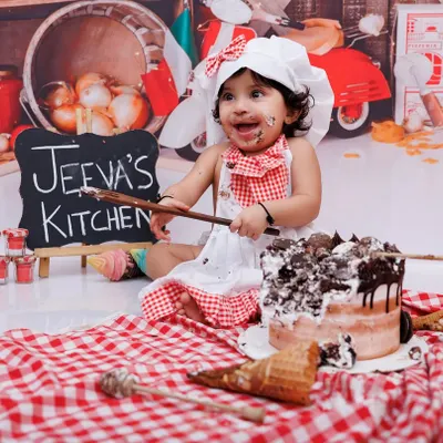 A messy cake smash is the best cake smash! This little chef had a blast digging into her first birthday cake.