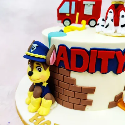 A close-up of our Paw Patrol cake, showing the expertly crafted fondant figure of Chase in his police uniform, ready for action.
