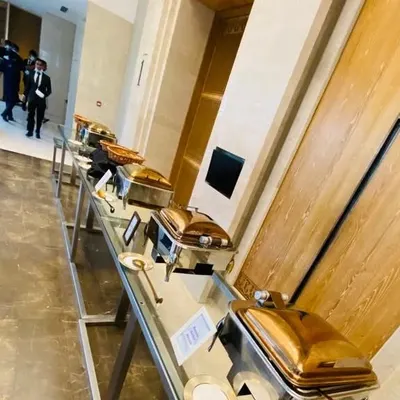 A long shot of our buffet setup for a housewarming party in a luxury residential building. The clean lines and metallic finish of our equipment provide a modern and sophisticated look.