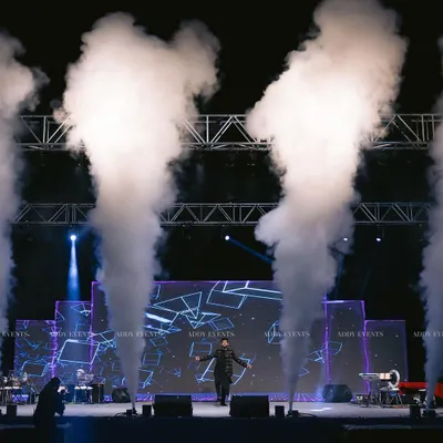 We create electric atmospheres that make your brand the main event. This shot captures the peak of a high-energy performance, complete with custom stage lighting and dramatic fog effects designed to captivate any audience at a corporate gala or product launch.