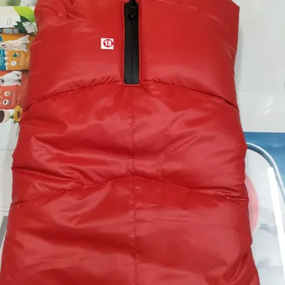 Keep your buddy warm with this red padded winter jacket. It has a soft, furry collar for extra comfort during cold morning walks.