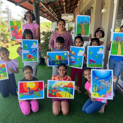 A group of proud young artists showing off their colorful oil pastel drawings from our first art camp of the season. We explored different themes and techniques, and the results were beautiful.