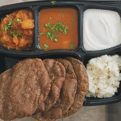My complete Navratri Thali for those who are fasting. It includes Kuttu ki Poori, Aloo Sabzi, Petha Sabzi, Samak ke Chawal, and fresh curd.