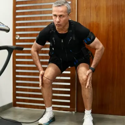 A client works through squat variations while the EMS suit amplifies every contraction, building strength and stability while reducing stress on joints.