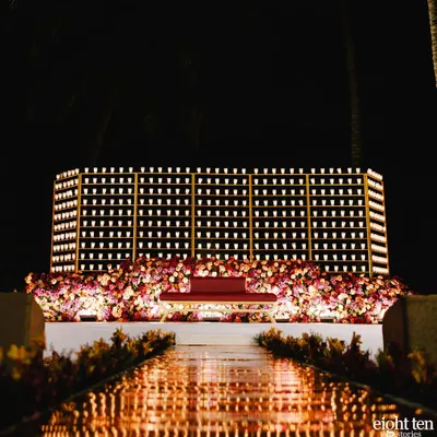 A full view of the spectacular candle wall I designed for a reception stage. The grid of hundreds of glowing candles created an incredibly romantic and dramatic backdrop for the entire evening.