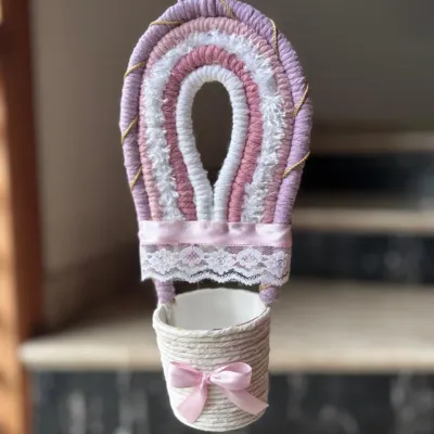 Drift into dreamland with this soft pastel macrame hot air balloon. It adds a touch of uniqueness and whimsy to your child's nursery, and can be customized in your favorite colors.