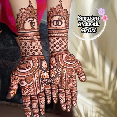 A perfect design for an engagement. This semi bridal henna features the couple's initials 'TP' and wedding rings, symbolizing their commitment.