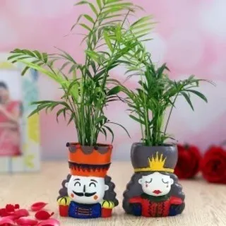 This charming king and queen planter set is a customer favorite for couples. Each detailed pot holds a small indoor palm, making it a playful and unique gift for anniversaries or weddings.
