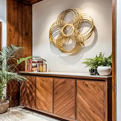 An elegant wooden console cabinet with chevron-patterned doors. This piece serves as a beautiful storage unit for a hallway or dining area, topped with plants and a striking piece of wall art.