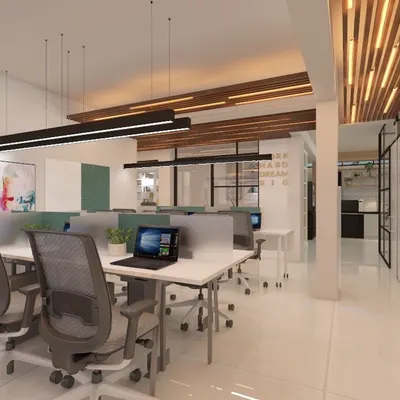 An open-plan office design that encourages collaboration, featuring shared workstations and glass partitions for private cabins. The ceiling combines wooden slats with modern linear lighting, creating a dynamic and professional atmosphere.