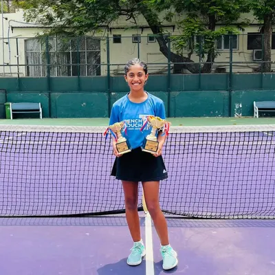 A champion's smile. Our student Eshal Pathan proudly displays her singles finalist and doubles winner trophies from the All India U16 Championship Series.