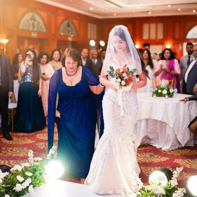 The bride's emotional walk down the aisle, escorted by her mother. A powerful moment from a beautiful Christian wedding ceremony at Jaypee Hotels.