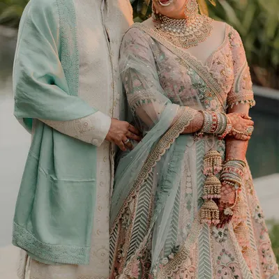 A beautiful portrait of a couple in pastel outfits, capturing a moment of quiet connection in a garden setting.