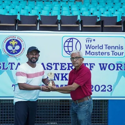 Our founder, Amogha Shivaram, receiving a trophy at the ITF World Tennis Masters Tour. His ongoing success as a player directly informs our practical and athlete-centric approach to event management.
