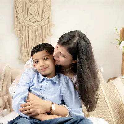 A mother's gentle kiss. These are the quiet, love-filled moments I aim to freeze in time during my family portrait sessions.