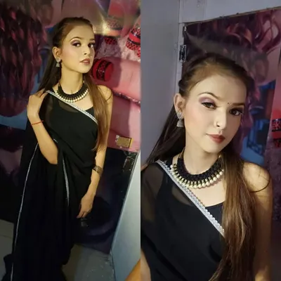 Our students learn to create polished looks for any occasion. This is a classic party makeup look, featuring subtle smokey eyes and a defined lip, perfectly complementing the modern black saree. This is a portfolio-ready shot from a student's practice session.