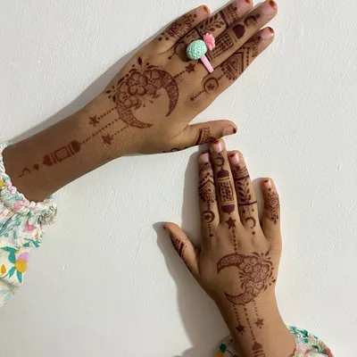 A cute and festive Eid design for a child, featuring crescent moons, stars, and hanging lanterns.