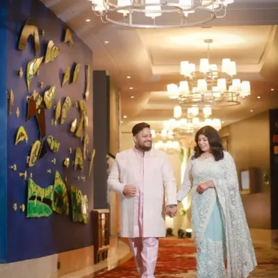 A classic couple portrait taken during their reception. The grand hotel corridor and elegant lighting provide a beautiful backdrop, and I focus on capturing the couple's relaxed and happy demeanor as they walk hand in hand.