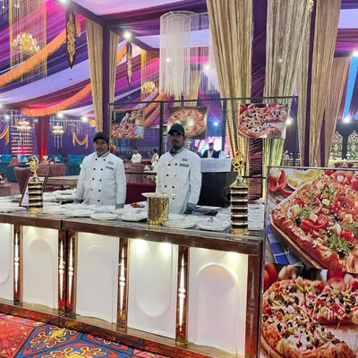 A dedicated live pizza station is a fantastic way to delight guests of all ages. My chefs are seen here in professional uniforms, ready to bake fresh pizzas with a variety of toppings, bringing a fun, international flavor to the wedding menu.