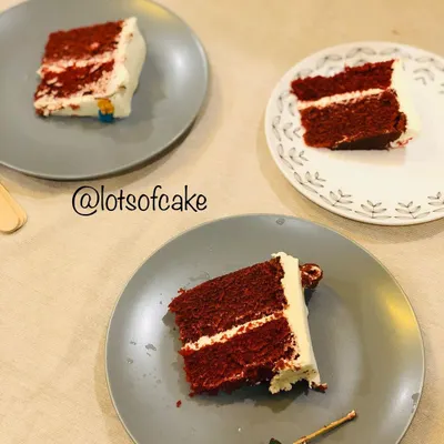 Slices of my classic red velvet cake served and ready to be enjoyed. Each slice shows the vibrant red sponge layered with my special cream cheese frosting that's not too sweet.