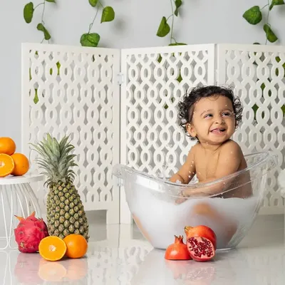 A bubbly, happy splash in the tub. Our milk bath sessions are designed to be pure fun, and this little one's smile says it all.