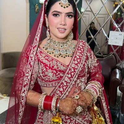A stunning full-length view of my bride in her magnificent red and gold lehenga. The makeup is kept classic and radiant to let the intricate outfit and her beautiful smile shine.