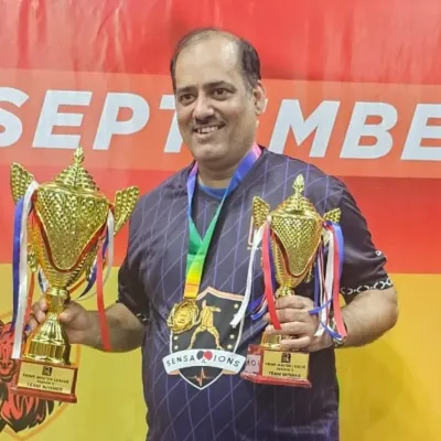 Our veteran player, Onkar Jog, holding the trophies for his team's victory in the Prime Master League. His success proves that passion for table tennis has no age limit.