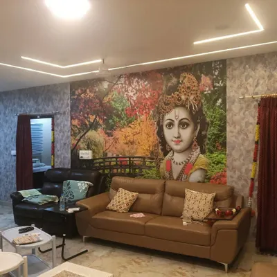 A large, colorful mural of Lord Krishna as a child, creating a vibrant and divine focal point in this living room.