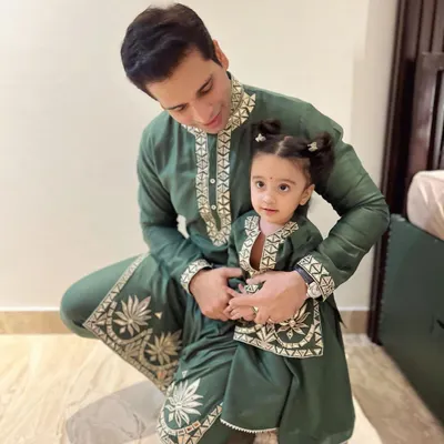A heartwarming father-daughter moment. I designed these twinning outfits for Diwali, featuring a bottle green mul mul kurta with leather embroidery for dad and a matching mini version for my daughter, Aarriya.