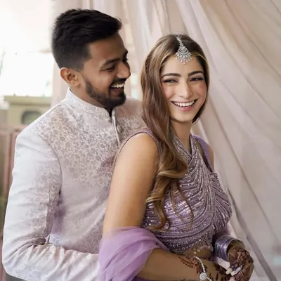 The laughter that starts a lifetime together. This candid shot from their engagement shoot perfectly captures the joyful, easy love between the couple.
