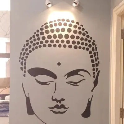 A minimalist Buddha face stencil, perfectly centered and highlighted by a spotlight, creating a tranquil and modern spiritual focal point.