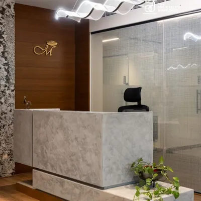 The reception at Meghana Foods corporate office sets the tone for the entire space. We used a monolithic concrete finish desk, a feature marble wall, and a sculptural light fixture to make a bold first impression.