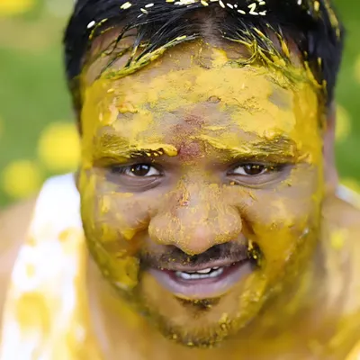 A close-up of the groom during his Haldi ceremony. We love capturing the fun and messy moments that make this ritual so memorable. His expression is a perfect mix of surprise and joy.