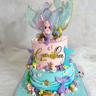 Make waves with this dreamy, two-tier mermaid theme cake. It features beautiful pastel colors, shimmering rice paper sails, and lots of underwater details.
