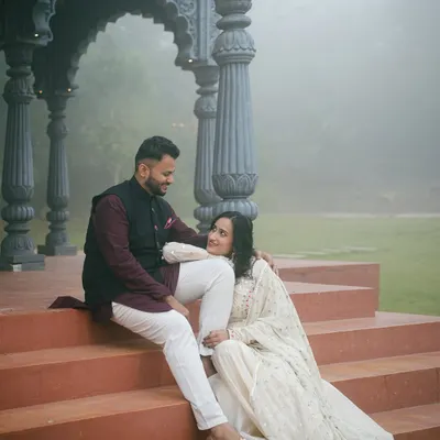 A quiet moment between a couple, framed by the ornate pillars of our studio's gazebo set. The soft, misty background creates a serene and intimate atmosphere for this pre-wedding photo.