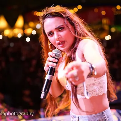 Shaheen Salmani of the band Rocknaama pointing right at the lens, connecting with the audience. I get right in the action to capture these interactive and engaging moments during live band performances.