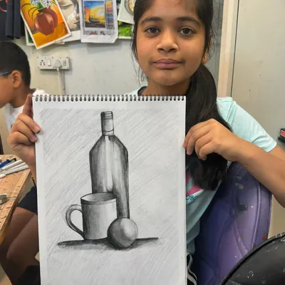 This still life drawing by a young student is a perfect example of our pencil shading lessons. She learned how to use different grades of pencils to create smooth gradients and define the shapes of the objects.