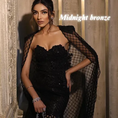 The "Midnight Bronze" look. This is the epitome of evening sophistication, featuring mesmerizing bronzed eyes, flushed nude-pink lips, and a chic top knot bun.