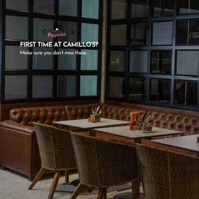 A view of our cozy indoor seating area, with comfortable leather booths and warm lighting. It’s a welcoming space designed for lingering conversations and memorable meals.