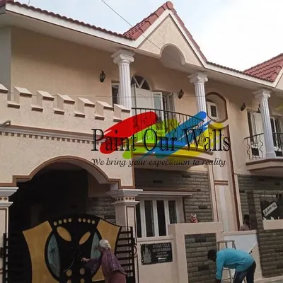 A full view of a completed exterior project in Bengaluru. The black paint on the balcony railings and the custom finish on the main gate are designed to withstand the elements and look great for years.