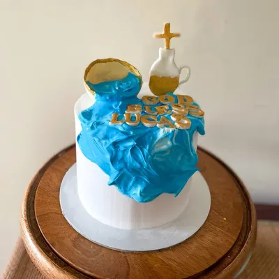 A special cake for a Holy Communion. The client requested a whipped cream cake with minimal fondant, so I created this design with a "waterfall" of blue cream and gold fondant accents.