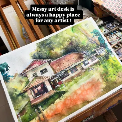A messy art desk is always a happy place. This is a commissioned watercolor of an ancestral home, a magical piece to work on, seen here resting on my easel.
