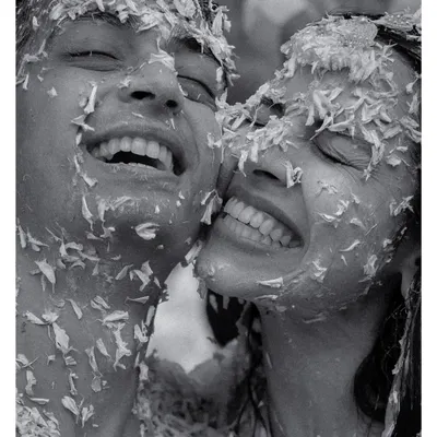 The pure, unadulterated joy of a haldi ceremony. This black and white candid shot of Amala and Aditya covered in flower petals is what we live for, capturing the real emotions that make a wedding memorable.