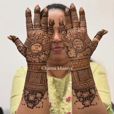 A beautiful, full-coverage bridal mehendi with the classic Hindi phrase "Dulhe ki Dulhan" (Groom's Bride) written in the center. The design is packed with intricate traditional patterns.