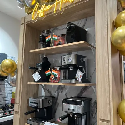 A shot from the Wonderchef store launch, showcasing their range of coffee machines. The setup highlights the products in a retail environment, complete with branding and festive decorations, making it ideal for event coverage or promotional materials.