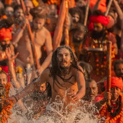 A Naga Sadhu taking a holy dip during the Maha Kumbh Mela. Witnessing this raw devotion is a powerful and unforgettable part of the experience.