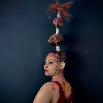 This stacked bubble braid is a perfect example of the avant-garde styles we teach. Students learn to create gravity-defying structures and use color for dramatic effect, perfect for fashion shows or creative portfolios.