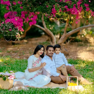 We begin our outdoor sessions by creating a comfortable, classic family portrait. Seated on a picnic blanket under a flowering tree, this family’s coordinated outfits and relaxed smiles set a warm and inviting tone for the entire shoot.